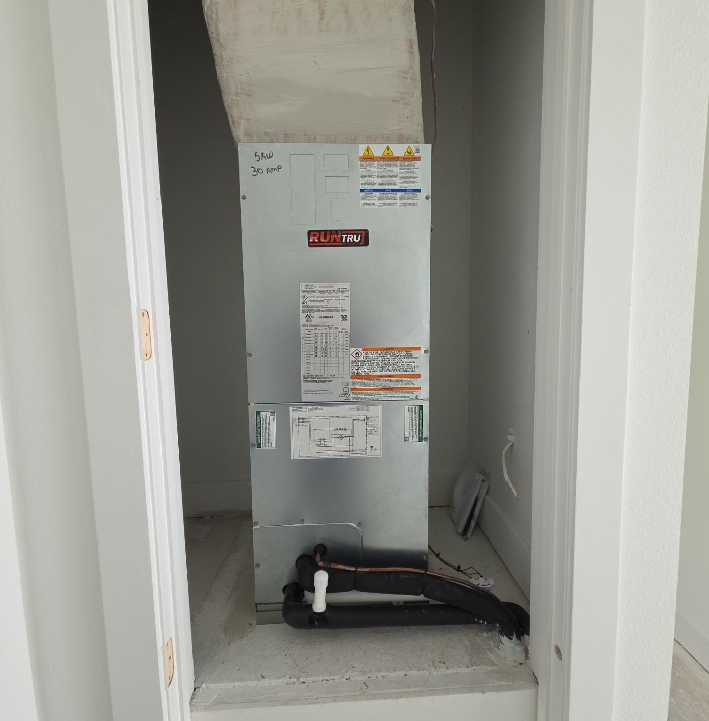RunTru HVAC system installed in a closet, showing wiring and labels