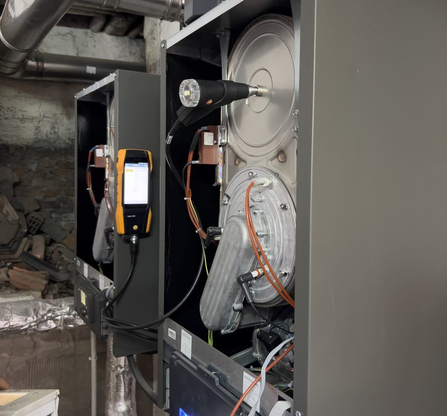 Industrial machinery with cables and digital device in a factory setting.